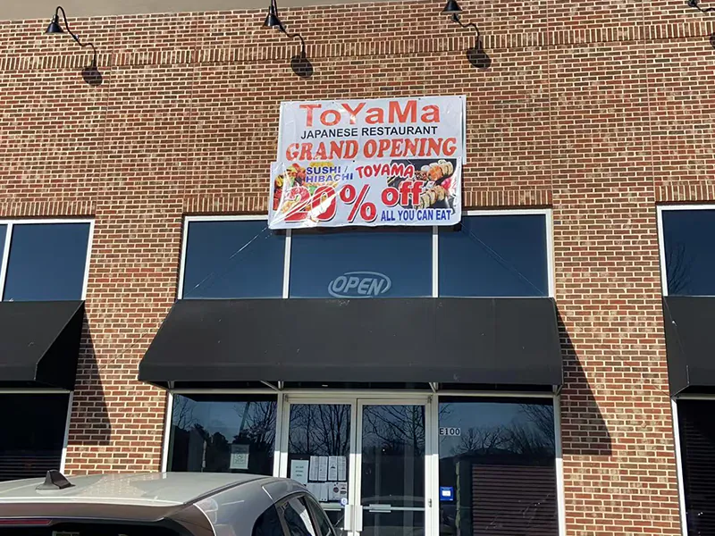 Exterior of the Japanese restaurant with grand opening sign at Toyama Sushi Steahouse, a Japanese Restaurant in Dacula